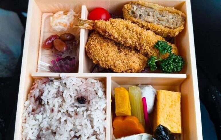 Wooden bento Box filled with very typical Japanese food