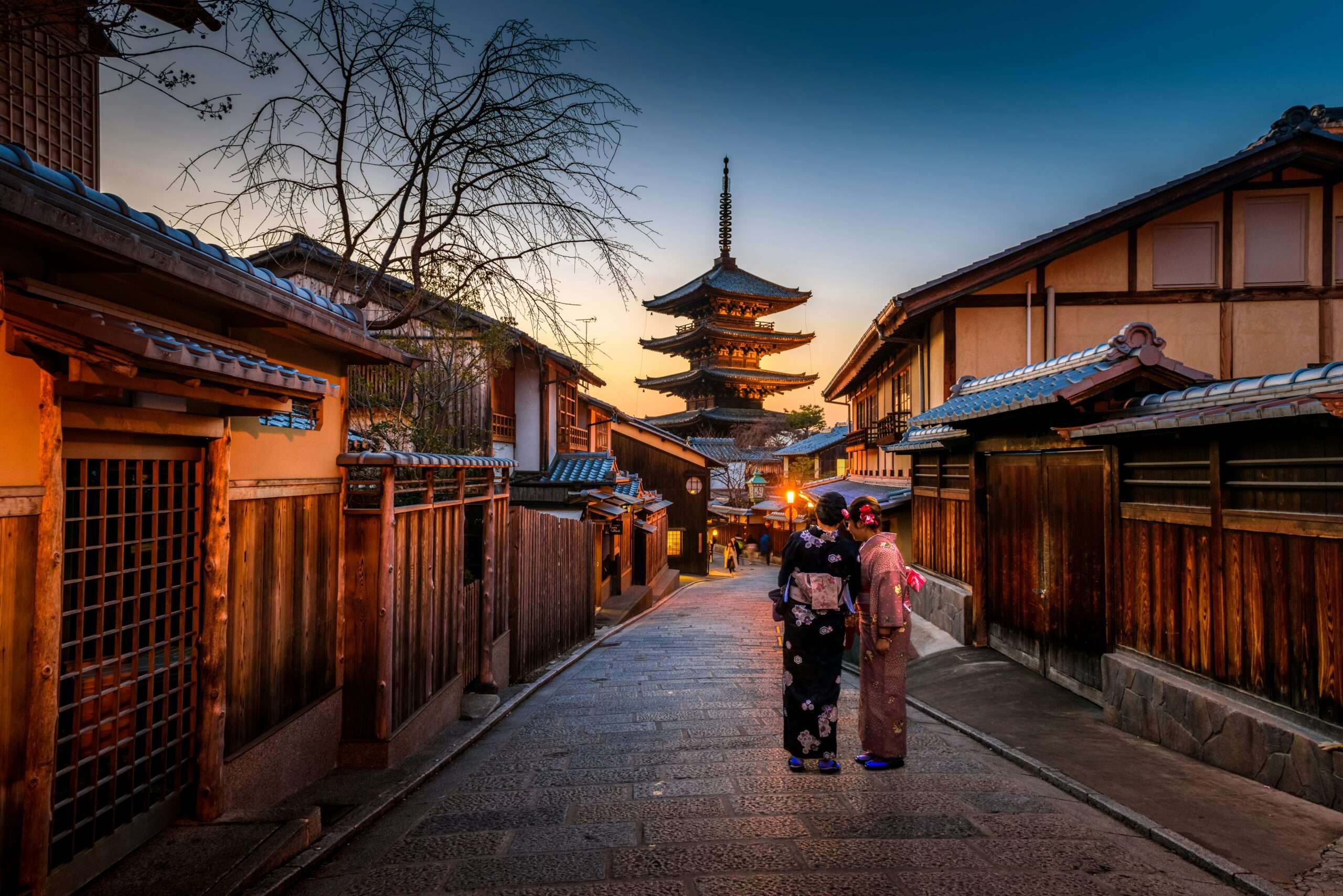 2 women dressed in japanese traditional kimono standing in famous sannenzaka street in Kyoto